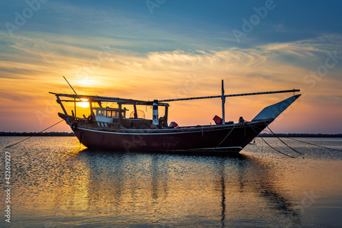 Single boat on Dammam sea side with sunrise background view. Dammam, Saudi Arabia.