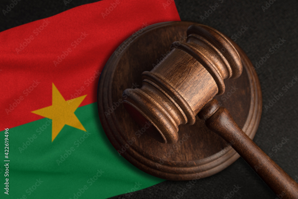 Judge gavel and flag of Burkina Faso. Law and justice in Burkina Faso. Violation of rights and freedoms