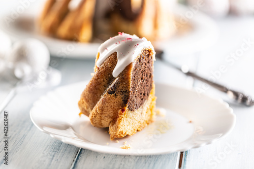 A cut piece of Easter marble cake on a white plate photo