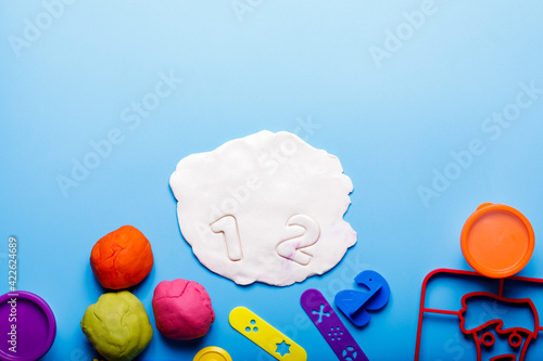 Homemade plasticine, plasticine, play dough on a colored background. Molding clay photo