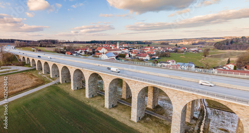 Bavarian Arched Bridge in famous Holledau region with a city shape at the background
