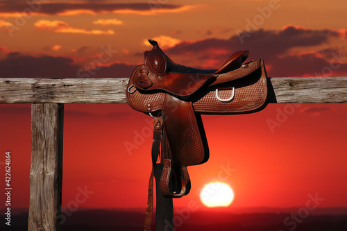 Horse saddle on rural fence