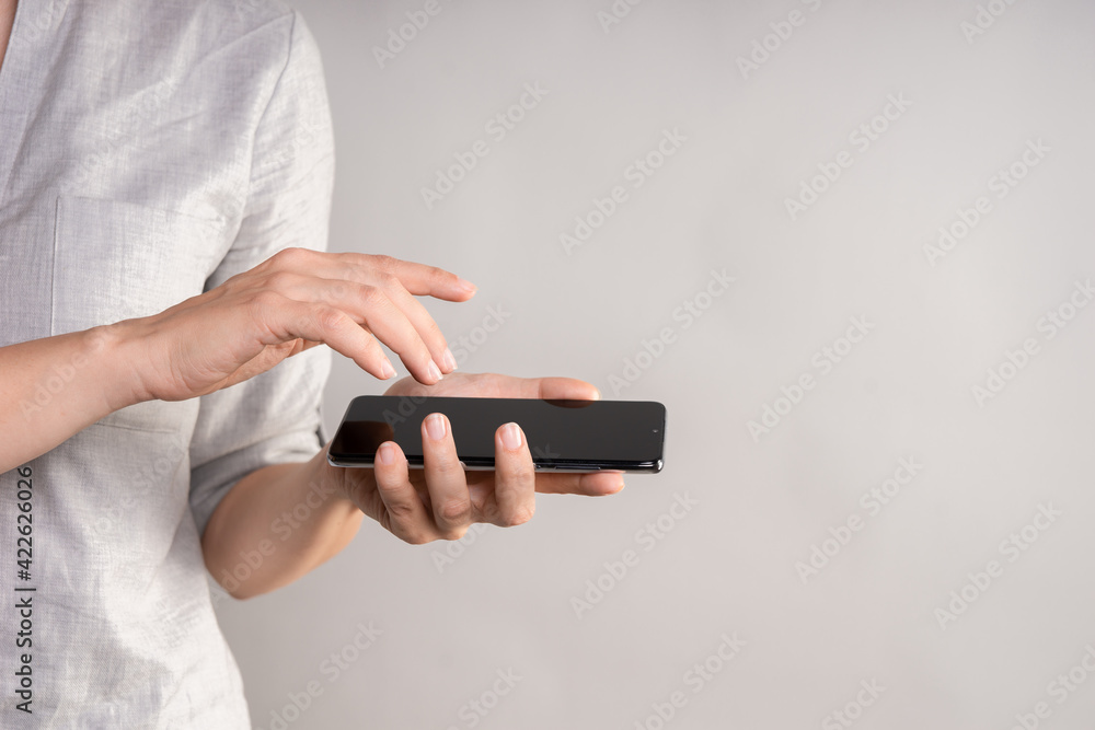 smartphone with a touch screen in a woman's hand. Use your phone with a