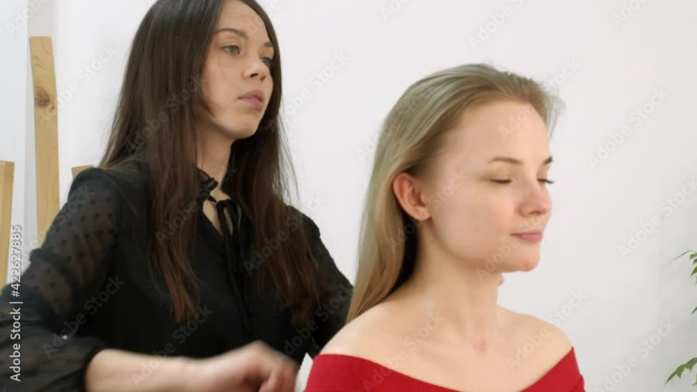 a beautiful blonde in a beauty salon does hair styling a beautiful blonde in a beauty salon does hair styling