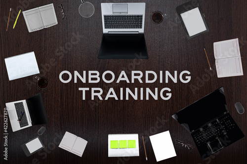 Wallpaper Mural Top view of Onboarding training text on the table with laptops, notepad, coffee, eyeglasses, pens. Business concept. Torontodigital.ca