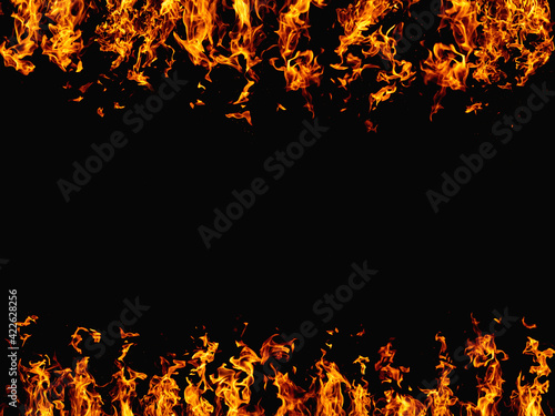 Flame background. Hot frame. Blaze heat. Bright orange yellow wildfire glow with spark texture isolated on black night abstract empty space banner.
