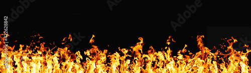 Hot banner. Fire flame texture. BBQ heat. Bright orange yellow warm grill fireplace with sparks isolated on dark night abstract empty space background.