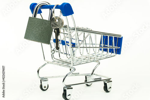 Grocery cart. The lock and keys hang on the handle. Isolated