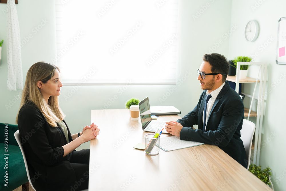 HR manager in a suit doing an interview with a woman