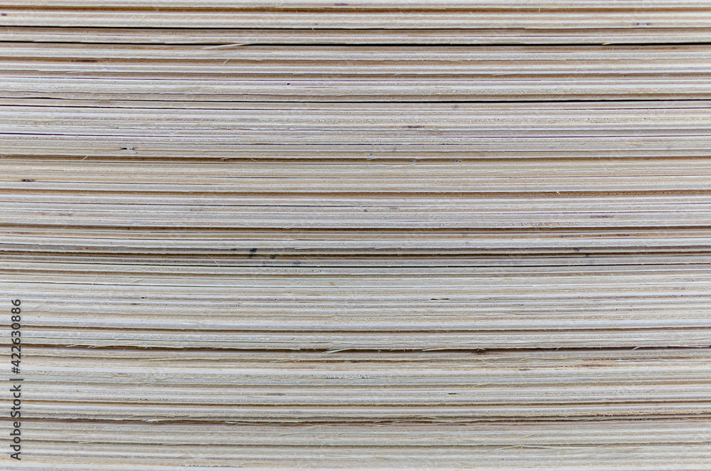Plywood stacked in sheets in a bundle. Plywood stacked in sheets in a bundle.