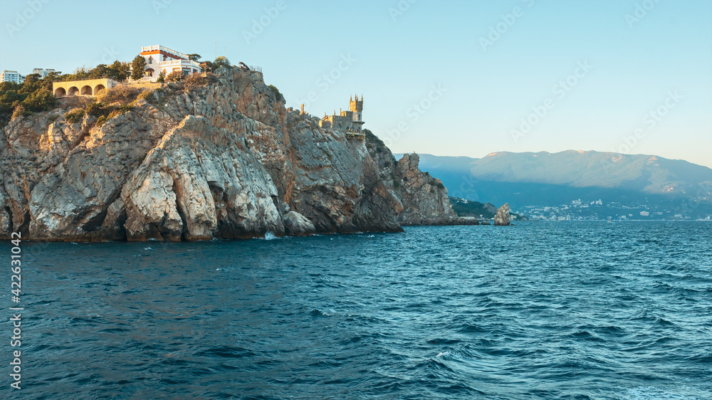 beautiful sea sunset on the Black Sea coast against the backdrop of a rock and a gothic castle at its top