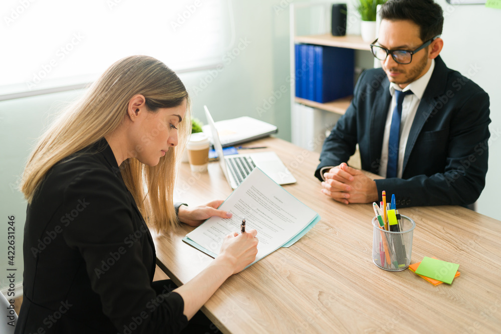 Attractive HR manager hiring and giving a contract to a woman Attractive HR manager hiring and giving a contract to a woman