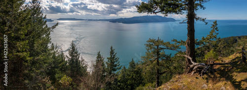 Western View of the San Juan Islands and the Salish Sea from Lummi Island, Washington. The top of Lummi Mountain provides a panoramic view of Orcas Island during a lovely springtime sunny day.