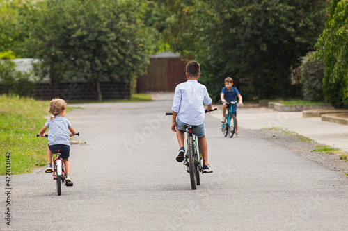 Kids have a leisure on bicycles outoodrs
