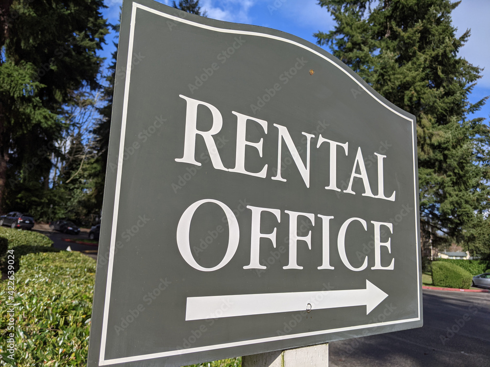 view of a sign pointing out the direction of an apartment rental office in a large community view of a sign pointing out the direction of an apartment rental office in a large community