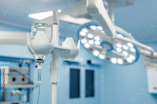 Tableau sur toile A dropper with medication in the operating room against the background of medical equipment