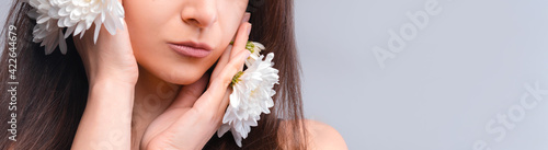 Close up Portrait of a beautiful natural natural blue-eyed girl with white flowers in the wild. Nude make-up