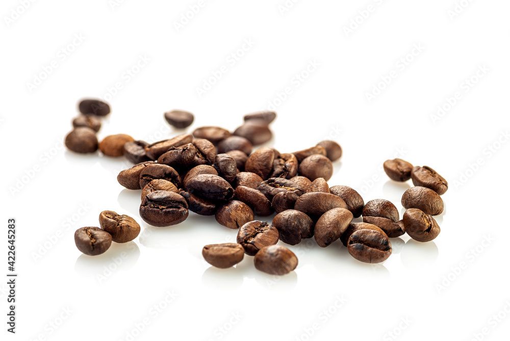Coffee beans scattered randomly on a white background Coffee beans scattered randomly on a white background