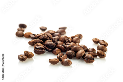 Coffee beans scattered randomly on a white background