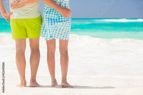 legs of young kissing couple on tropical turquoise caribbean beach. Cayo Largo, Cuba