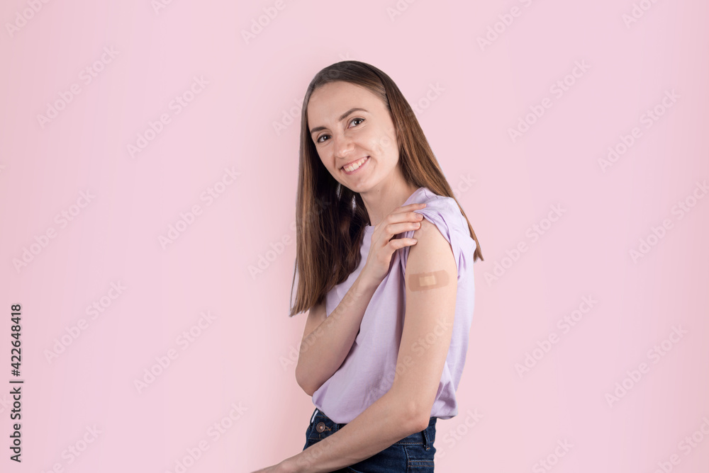 Young women with adhesive bandage after vaccination Young women with adhesive bandage after vaccination