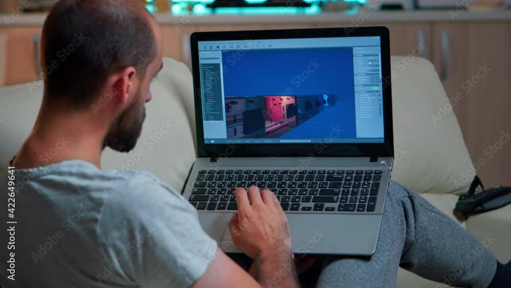 Caucasian game developer working on gameplay and game level late at night from the confort of his home. Professional creative man in the evening developing startup technology Caucasian game developer working on gameplay and game level late at night from the confort of his home. Professional creative man in the evening developing startup technology