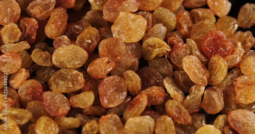 Raisins background rotate slowly. Sweet raisins slow sliding. Close up food background. Gastronomy concept, organic food. Macro fruit dolly shot. Assorted colorful raisins, close up. Raisins background rotate slowly. Sweet raisins slow sliding. Close up food background. Gastronomy concept, organic food. Macro fruit dolly shot. Assorted colorful raisins, close up.