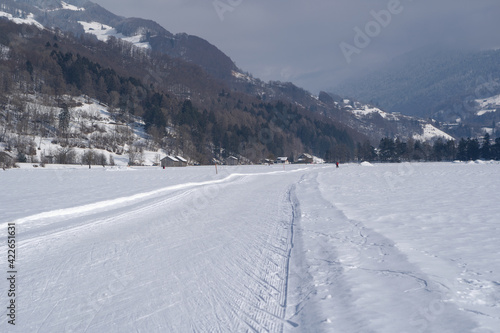 Winter mountain landscape with groomed cross-country trails. Swiss Alps, Switzerland, Europe