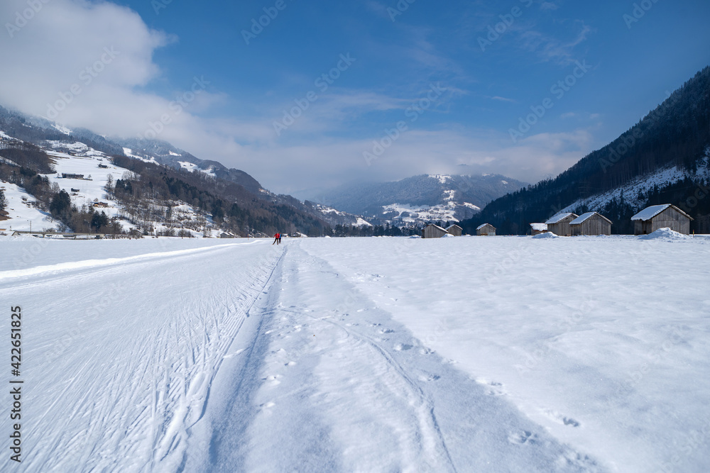 Obraz premium Winter mountain landscape with groomed cross-country trails. Swiss Alps, Switzerland, Europe