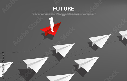 Silhouette of girl standing on red origami paper airplane go different way from group of white. Concept of future and children disruption.