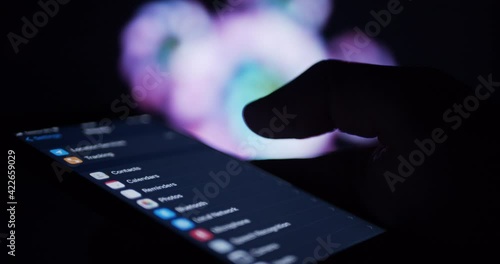 User looking at privacy settings on smartphone device - online cyber defence
