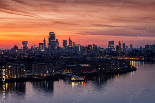 The illuminated skyline of London, United Kingdom, along the Thames River to the City just after sunset during dusk