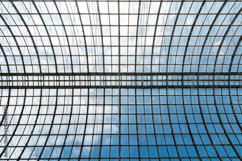 Transparent roof of the building made of glass and metal. Background.