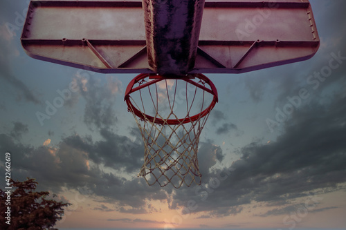 Neighborhood Basketball Hoops and Colorful Skies photo