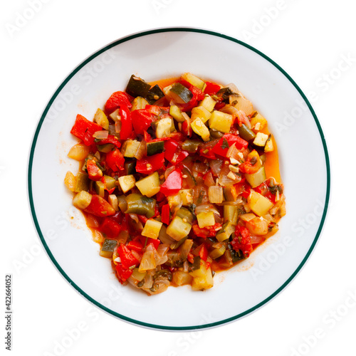 Stewed vegetables - bell peppers, zucchini and parsley. Isolated over white background