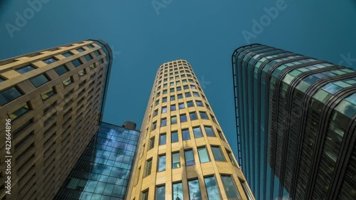 Daytime timelapse of business quarter in moscow near white square, a lot of people and cars are on the street at sunny day. sun and cloud reflection
