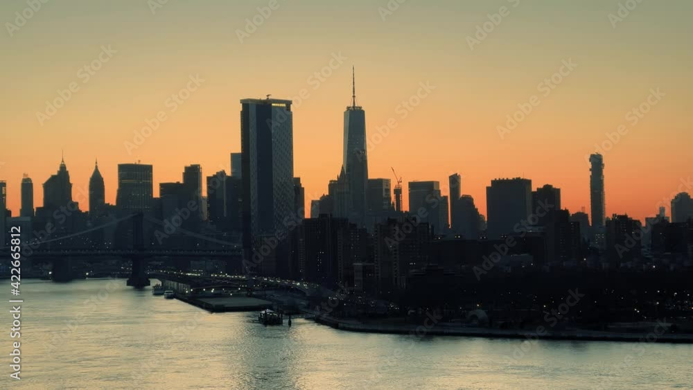 Freedom Tower and Manhattan skyline after sunset silhouette buildings skyscrapers East River water New York City NYC Freedom Tower and Manhattan skyline after sunset silhouette buildings skyscrapers East River water New York City NYC