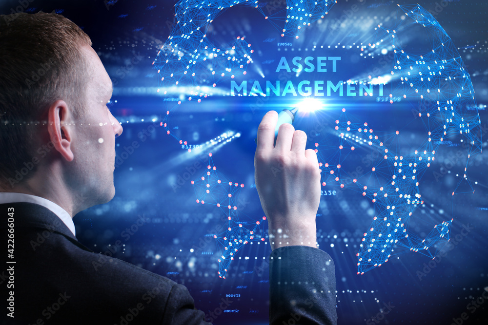 Business, Technology, Internet and network concept. Young businessman working on a virtual screen of the future and sees the inscription: Asset management Business, Technology, Internet and network concept. Young businessman working on a virtual screen of the future and sees the inscription: Asset management