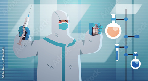 scientist developing coronavirus vaccine in lab researcher holding syringe and vial vaccine development
