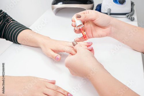 Manicure process in a beauty salon. Manicure master and client.