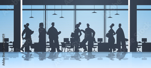 businesspeople silhouettes working in office business people group discussing during meeting teamwork concept