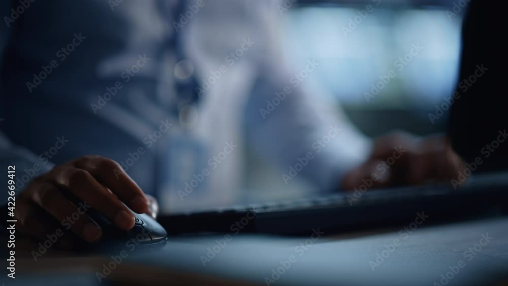 Close Up of a Professional Office Specialist Working on Desktop Computer in Modern Technological Monitoring Control Room with Digital Screens. Manager Typing on keyboard and Using Mouse.