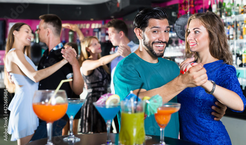 Female with man are dancing in pair on party in the bar