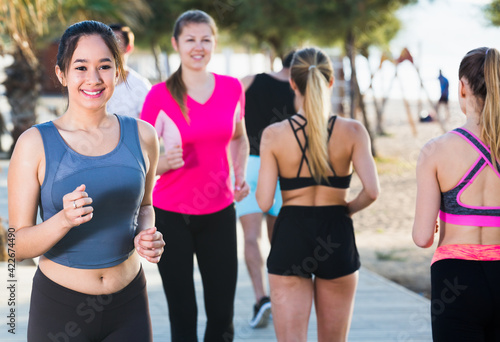 People leading healthy lifestyle, jogging during outdoor workout on city seafront