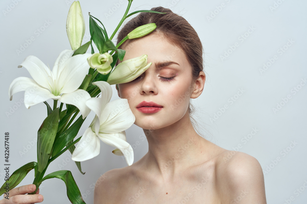 woman with white flowers on gray background portrait close-up makeup mode woman with white flowers on gray background portrait close-up makeup mode