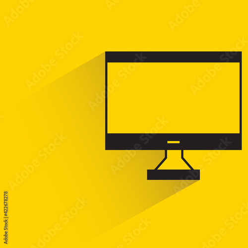 desktop computer with shadow on yellow background