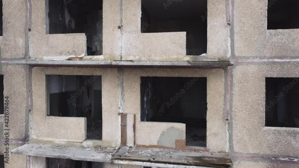 An abandoned ghost house with broken windows and burnt out apartments, an empty house without people like a horror. An abandoned ghost house with broken windows and burnt out apartments, an empty house without people like a horror.