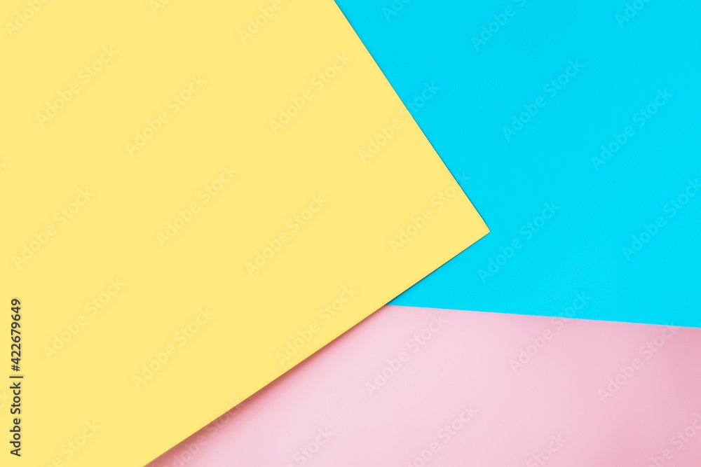 Multicolored sheets of paper placed geometrically randomly. Yellow, pink, blue Multicolored sheets of paper placed geometrically randomly. Yellow, pink, blue