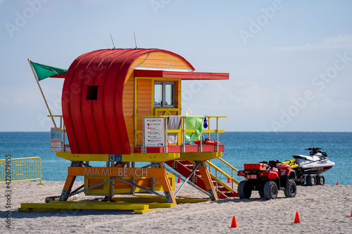 Orange lifeguard toewr Miami Beach FL with green flag safe swimming conditions © Felix Mizioznikov