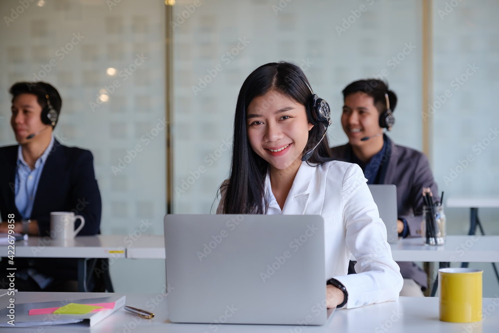 Female operator with her team before communicates with the client. Female operator with her team before communicates with the client.